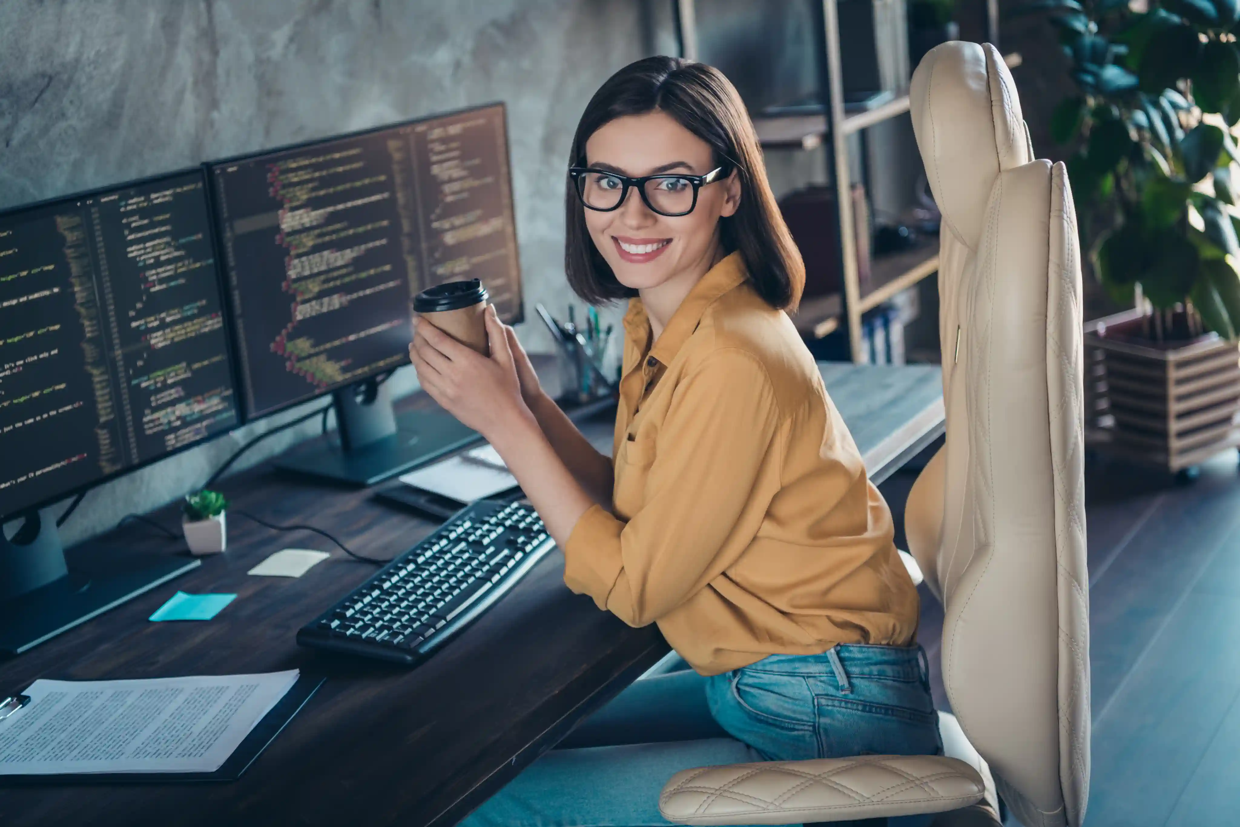 Female programmer drinking coffee at her desk